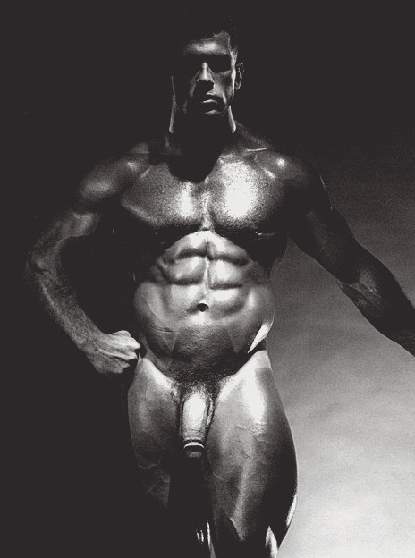 An original gelatin silver print by Jim French depicting the model Jake Tanner, a muscular white male with brown hair, posing nude in front of a black background.