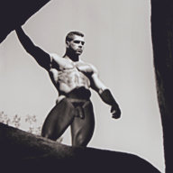 Jim French photograph "Jake Tanner, Joshua Tree" depicting the model Jake Tanner, a muscular white male with brown hair, posing nude in the center of a rock formation.